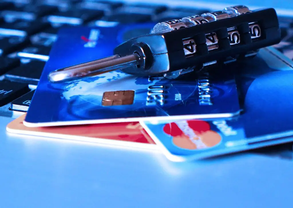 credit card purchase protection, a picture of credit cards and a lock with code on top