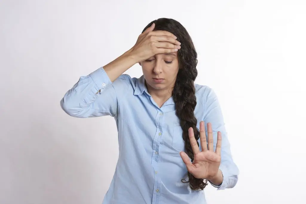 Why is buying a house so stressful? Woman with her hands on her forehead